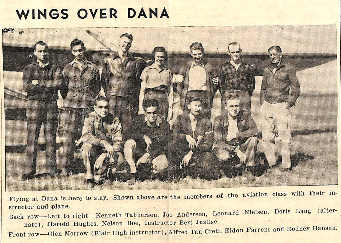 Dana College students in front of a small airplane, 1940-1941.