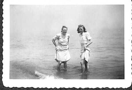 Two female Dane College students dipping their feet into Lake Michigan, 1942